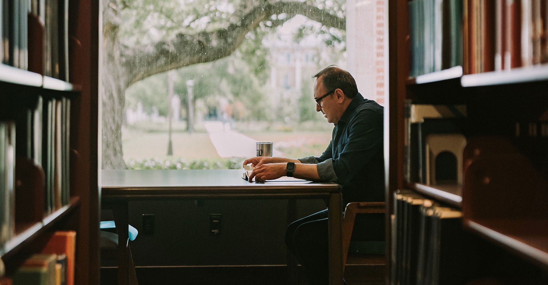 Flavio reading at a table