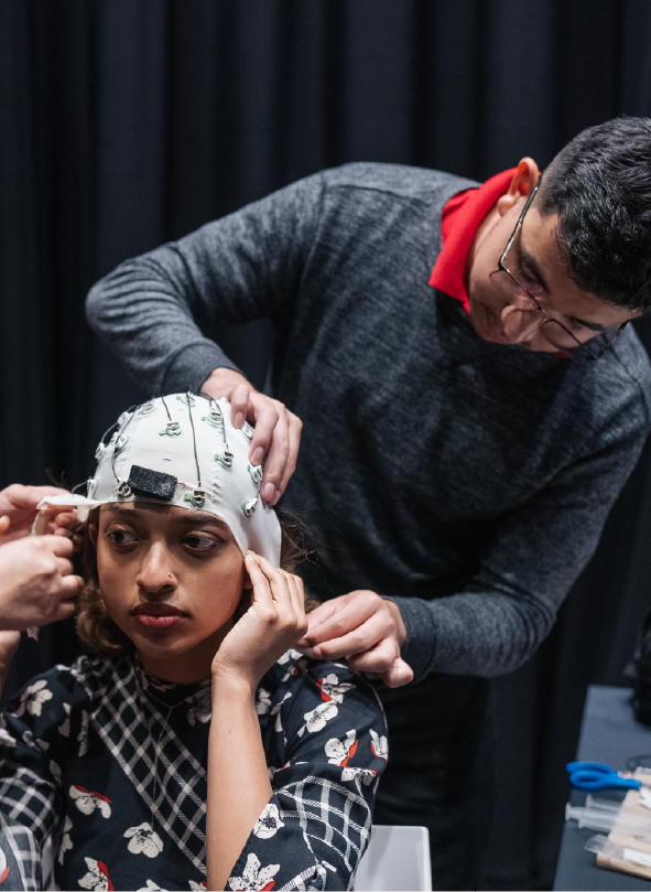 Mobile brain-body imaging equipment being placed on Chelsea DeSouza (DMA, '26)