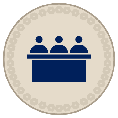 Icon of three people at a desk
